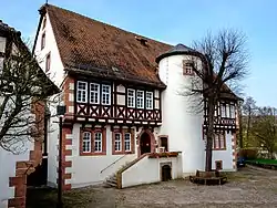 Exterior of the Brüder Grimm House in Steinau, a half-timbered historic building with a steep tiled roof.