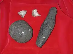 Stone tools of the Developed Olduwan from Cooper's D. Pictured are a hammerstone, an unknown object made of shale, and quartz flake tools
