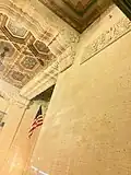 Ornate stonework and painted coffered ceiling.