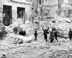 The Jews are being pulled out of the basements by Wehrmacht sappers and SS troops.