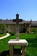 Cross the courtyard of the monastery