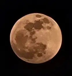 Photo of large, reddish Moon during a lunar eclipse