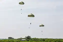 Japan Ground Self-Defense Force paratroopers conduct an airborne jump onto a drop zone in Baturaja, Indonesia, during Super Garuda Shield 2025, in Baturaja, 27 August 2025.
