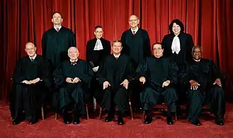 Group photo of United States Supreme Court Justices from 2009. Optional formal dress can be seen under the robes, such as bow ties. Justice Sonia Sotomayor and Justice Ruth Bader Ginsburg also wear lace jabots.