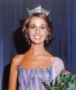 A color photograph of a woman wearing a beauty pageant crown