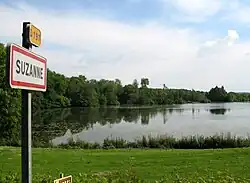 The lake and entrance sign to Suzanne