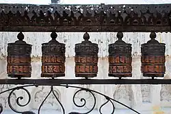 Rolling metal prayer wheels circling the Swayambhunath stupa, Kathmandu
