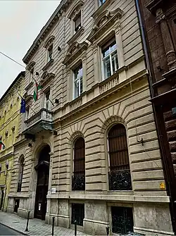 The Szentkereszty Palace at Horánszky utca 15. Built in 1898 for Transylvanian Baroness Maria Szentkereszty de Zágon,née Florescu de Floresti et Vizuresti, born in 1857 into the Florescu family from Wallachia/Moldavia with deep roots in the Romanian nobility. Her husband Béla was a member of the Hungarian Transylvanian nobility. Sándor Fort was the building's architect. The building became the Romanian legation in the 1920s. Raoul Bossy, Baroness Szentkereszty's nephew, became the minister in Hungary 1936-39. The embassy closed in August 1944 when Romania joined the allies. In 1956 it housed the Yugoslav embassy and briefly housed Prime Minister Imre Nagy. The Szentkereszty coat of arms still features above the gateway.