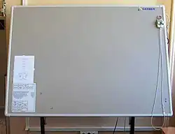 A large-format graphic tablet by manufacturer Summagraphics (OEM'd to Gerber): The puck's external copper coil can be clearly seen. Note using of a Digitizer mouse with a magnifying glass.
