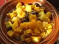 Tajine with lamb and mango. Tajine is a Maghrebi dish which is named after the earthenware pot in which it is cooked. It is also called maraq or marqa.