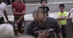 A man bows and holds his hand on the chest, expressing deference and respect