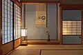 All of the paper visible in this photo — the shōji screens, the andon lantern covers, and the kake-jiku (掛軸, hanging scroll) — is made from washi (traditional Japanese paper)