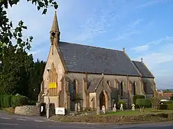Stone building with arched windows and small turret.