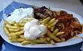 A "Taxi Teller" is a plate of fries served with currywurst, shashlik sauce, mayonnaise, gyros, and tzatziki.