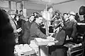 Tea and buns are supplied by local ARP workers to fellow workers and civilians in a basement shelter in south east London, 1940