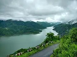 Blue reservoir with surrounding hills and lakeside settlement