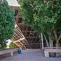 View of the building from behind mature trees