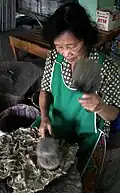 Pounding mulberry bark into pulp