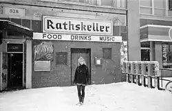 Snowy B&W image of the venue with a woman (Aimee Mann) standing in front
