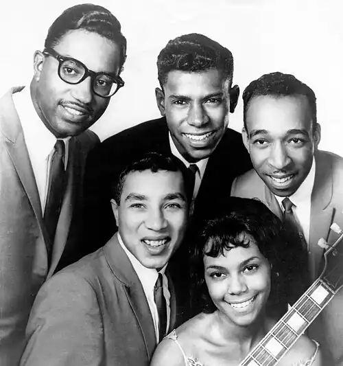 The Miracles in 1962. Clockwise from top left: Bobby Rogers, Marv Tarplin, Ronnie White, Claudette Robinson, and Smokey Robinson. Not pictured: Pete Moore.