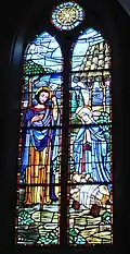 The Nativity – The glory of the first Christmas Day is celebrated in the window of the Holy Family. The artist depict Jesus' humble birth. This is the only gallery window that survived the fire of 1965 which destroyed the nave. Only one piece of glass was broken! The circle shows the star of Bethlehem.