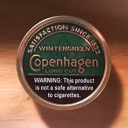 Can of dipping tobacco with warning: "WARNING: This product is not a safe alternative to cigarettes."