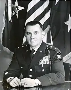 1954 black and white photo of Major General Thomas S. Timberman seated at desk in dress uniform