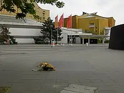 Bus terminal at the Philharmonie, in the foreground a plaque is set into the pavement to commemorate the victims of Aktion T4