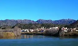 Tivenys over the Ebre river, the Serra de Cardó mountain range in the background