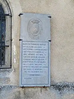 Stone attached to the wall of a tomb by iron supports in the corners, the inscription reads "In this tomb rests Mr. Claude Jacques Lecourbe, Count of the King, Lieutenant General of the King’s Armies, Grand Officer, Grand Cordon of the Legion of Honor, and Knight of Saint Louis, deceased, Commander-in-Chief of the Army of the East, at Belfort, on October 22, 1815"