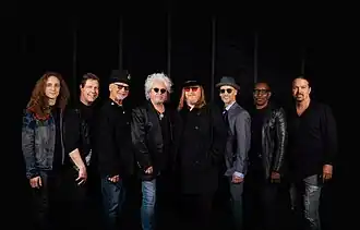 Toto in 2024. From left to right: Dennis Atlas, Warren Ham, David Paich, Steve Lukather, Joseph Williams, John Pierce, Greg Phillinganes, and Shannon Forrest