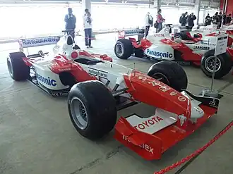 A red and white Formula One car on display.