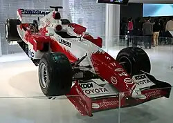 A red and white Formula One car on display.