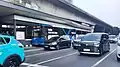 A northbound Transjakarta electric bus stopping at Petamburan station