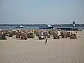 Excursion boats and roofed wicker beach chairs