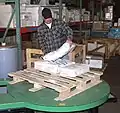A fixed-height turntable for pallets with short low stacks.