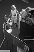 Children preparing to use a curving slide in Sacramento, California, 1963