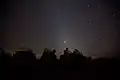 Vehicles of the U.S. Marine Corps under a starry sky at FOB Edinburgh, February 4, 2011.