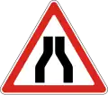 Road narrows on both sides