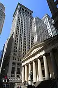 Federal Hall, once the U.S. Custom House, now a museum, with the towers of Wall Street behind it