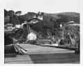 View from pier looking ashore and up at light station – U.S. Coast Guard Archive