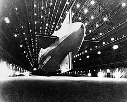 Macon showing its tail; unlike traditional rigid airship designs, the tail was not cruciform, with the stabilizers instead mounted onto the hull rings at the rear of the ship.