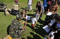 US Navy personnel handing out gifts and toys to the children of Udot (Aug. 29, 2008)