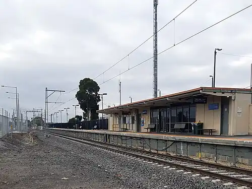 Upfield station platform viewed from Barry Road, looking north, showing station building