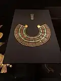 Tutankhamun's Usekh collar: the 18th Dynasty inlaid with glass and gemstones, symbolizing divine protection and currently housed in the Grand Egyptian Museum.[7]