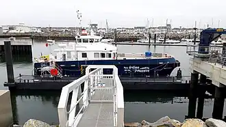 Moti' Vent offshore supply vessel for the Saint-Nazaire offshore wind farm moored at the EMR quay in the port of La Turballe.