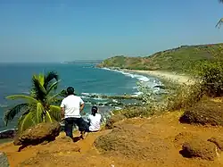 Clifftop view over a crescent beach and the Arabian Sea