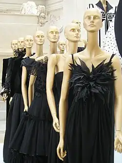 Line-up of mannequins wearing black, frilly dresses