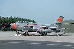 This aircraft lacks the nose-mounted cannons, but includes an extended, pointed nose and orange flight test markings.