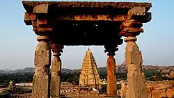 Virupaksha Temple gopuram framed by a stone mandapa